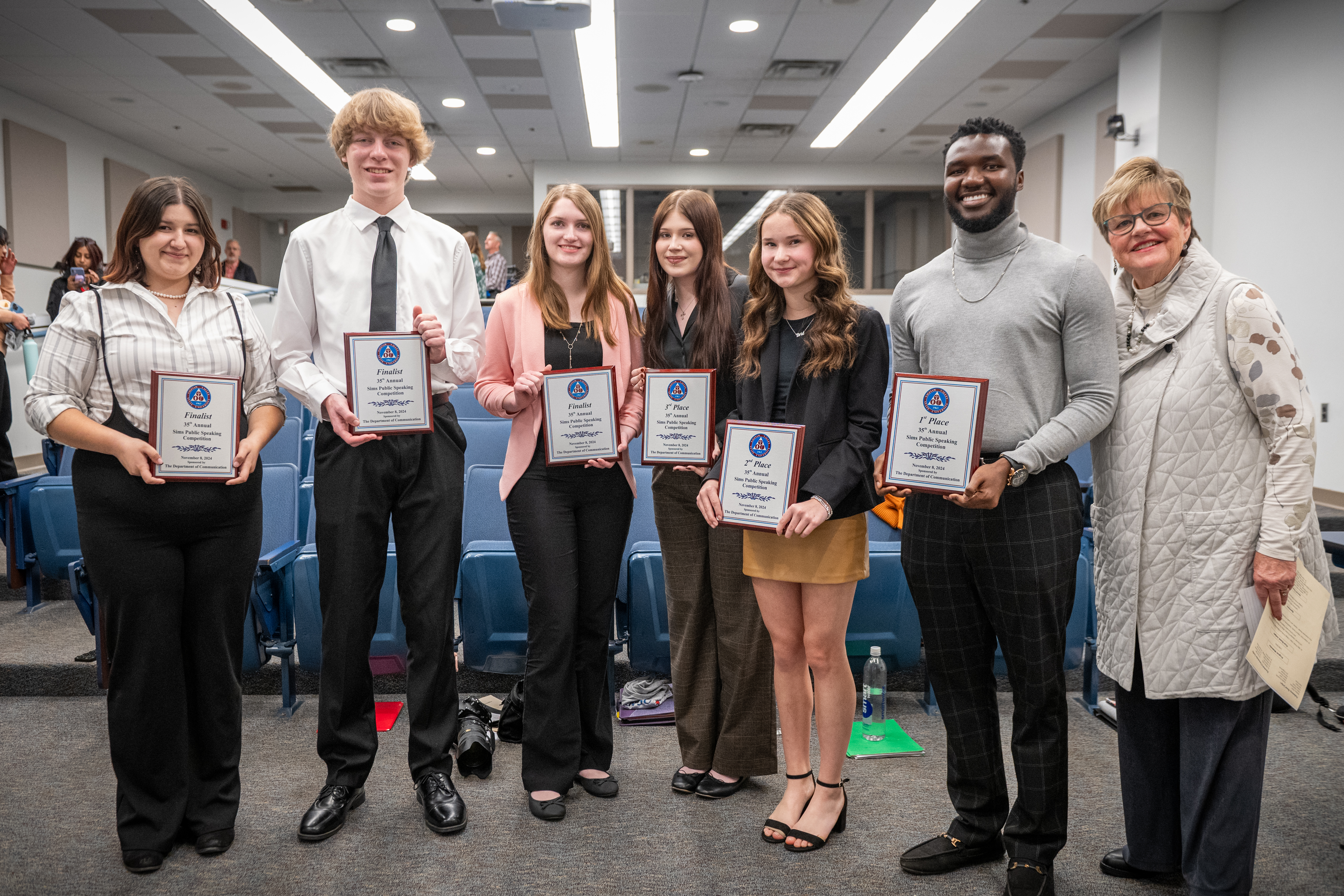 six students standing with Linda Sims